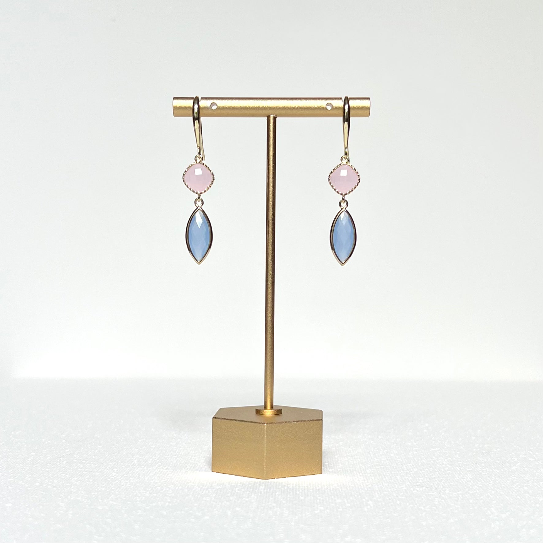 This earring set features a pale pink glass fancy bezel prong set charm and a pale blue glass marquis shaped bezel charm hung by a simple gold filled French hook. 
